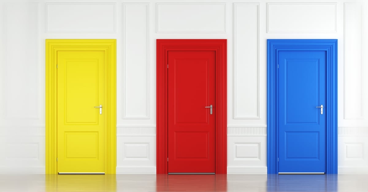 Three brightly colored doors in a white room.