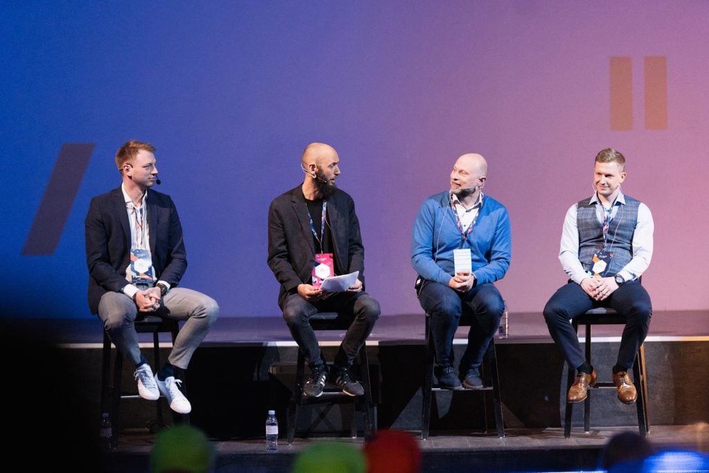 Panelists on stage at the Meet Magento Baltics conference hosted by scandiweb.